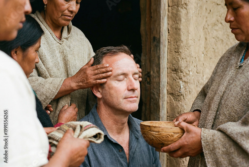Man receiving a head massage blessing during a wellness ritual in a traditional gathering space with a serene restorative mood