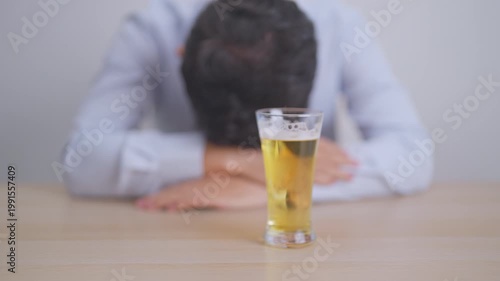 Stressed man drinking beer alone with problem. Exhausted drunk man looking stressed and sleepy. Alcohol addiction, Alcoholism, emotional distress and mental health concept