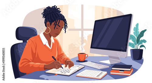 Focused young woman sits at her office desk with a computer monitor while diligently writing in her notebook during a productive work day.