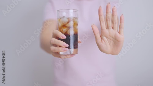 Healthy woman hand stop sign to refuse soft drink and soda, say no to sugar and carbonated beverage, healthy lifestyle, Acid reflux, Heartburn and Gastritis concept