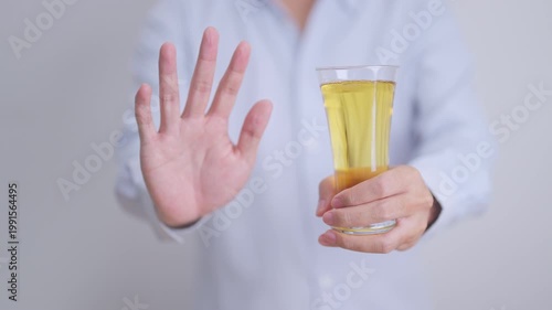 man making stop hand gesture to refuse a glass of Beer, Healthy man say no to alcohol drink, stop alcoholism and addiction concept. Responsible man reject a drink before driving and quit booze