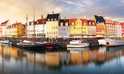 Quadro su tela Copenhagen colored building in Nyhavn with blue sky and sun, Denmark