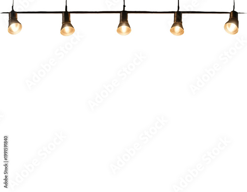 Five directional lamps illuminate against a bright, blank canvas