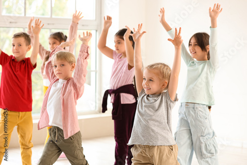 Group of cute little children dancing in studio