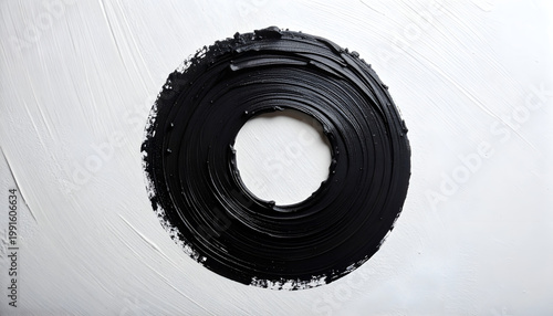 A striking abstract artwork features a bold black circle with a central void against a stark white background, showcasing textured brushstrokes and a minimalist aesthetic.