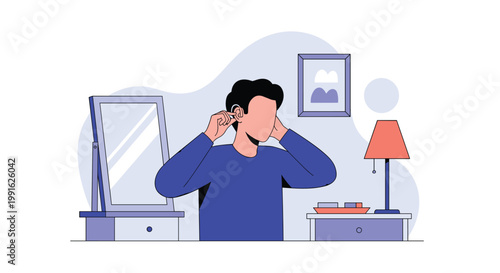 A man wearing a blue long-sleeved shirt stands in his bedroom and carefully adjusts a small hearing aid behind his ear for better sound and clarity.