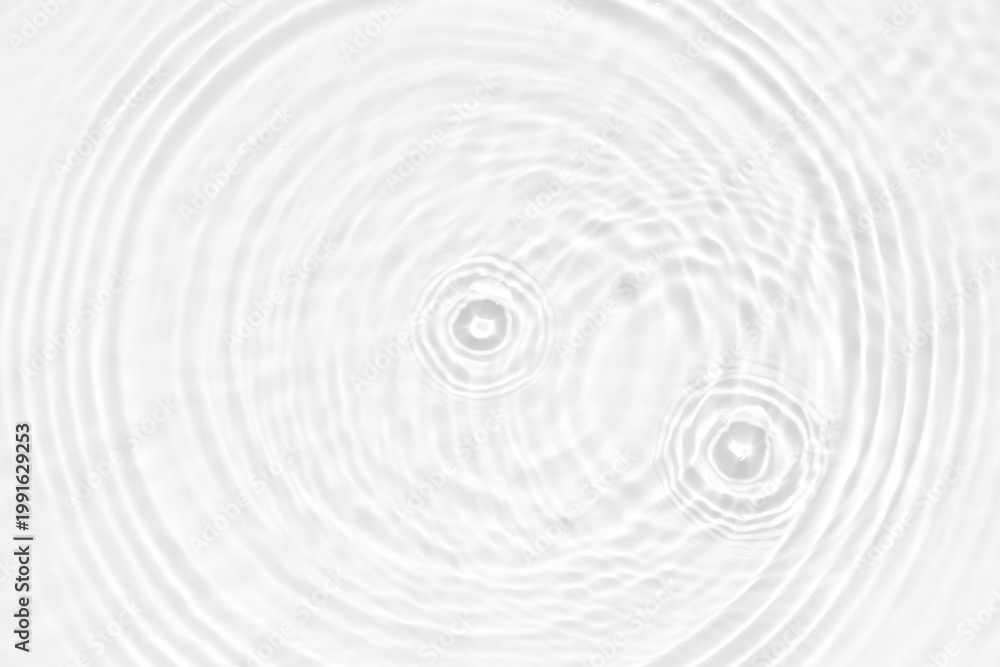 Obraz premium White water with ripples on the surface. Defocus blurred transparent white colored clear calm water surface texture with splashes and bubbles. Water waves with shining pattern texture background.