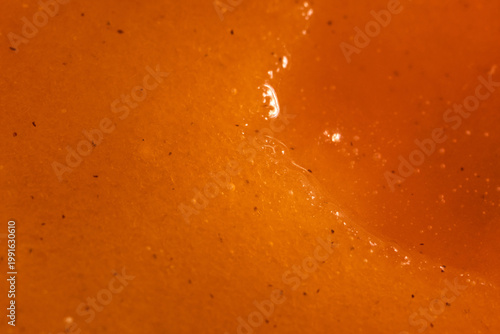 High quality shot capturing juicy apricot surface and textures. Photograph emphasizing glistening juice and porous texture of freshly picked apricot