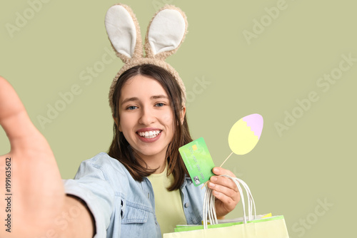 Young woman in bunny ears w...
