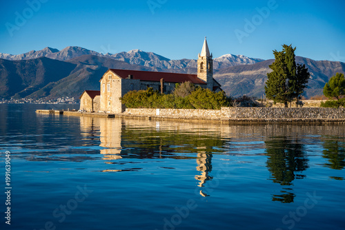 View of Our Lady of Mercy Island from yacht boat near Tivat city in Kotor bay of Adriatic sea in Montenegro in winter time