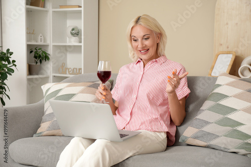 Mature woman with wine and ...