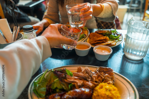 Photography Friends toasting drinks during a meal in san francisco restaurant