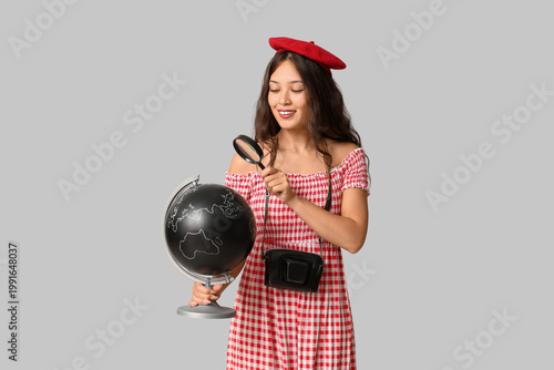 Young Asian woman with glob...