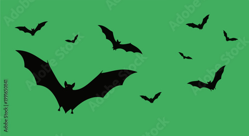 Silhouettes of black bats in various flying poses against a solid green background