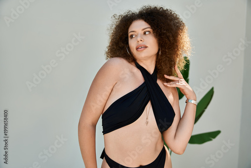 Beautiful plus size woman enjoying a sunny day by the poolside with confidence and grace
