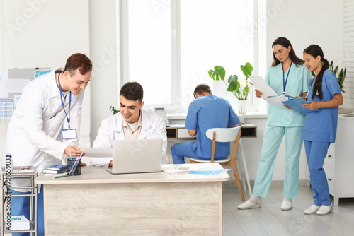 Male doctors working at tab...