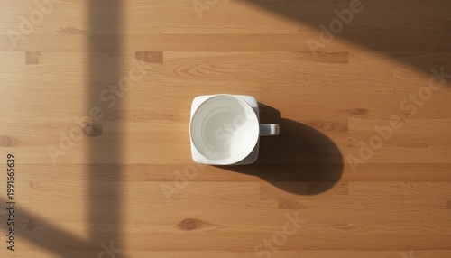 Minimalist White Cup on Wooden Table Casting a Soft Shadow in Morning Sunlight from Above
