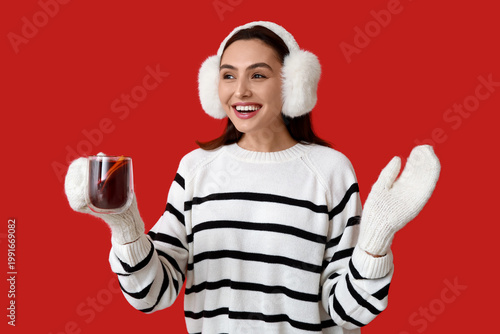 Happy young woman in warm m...