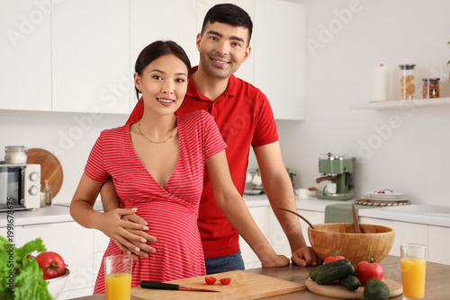 Happy young pregnant couple...