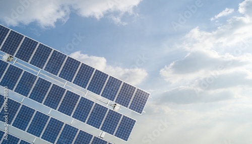 Aerial View of Solar Panels Under a Bright Sky with Clouds