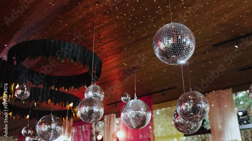 Clustered Mirrored Balls In Retro Lounge, Velvet Drapes And Chandelier Rings, Cocktail Setup, Polished Chrome. Disco Balls