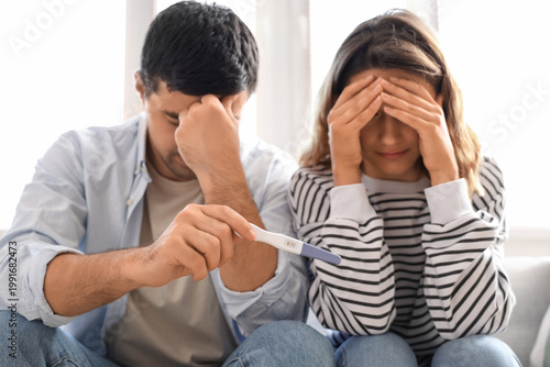 Upset young couple with pre...