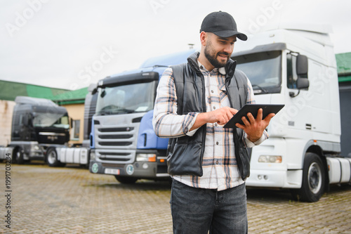 Bild auf Leinwand Truck driver using tablet for logistics management