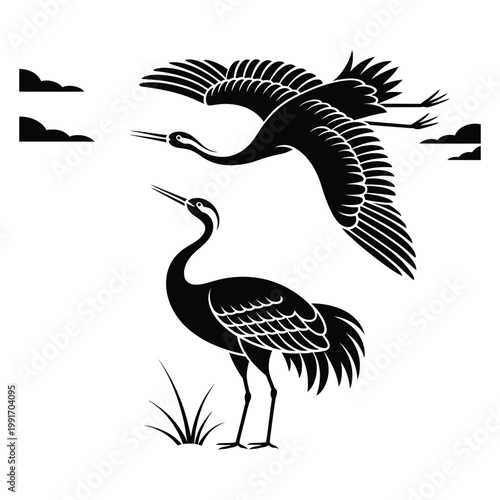 Two elegant cranes silhouette with one flying and one standing in marsh grass for traditional oriental nature art or wildlife conservation