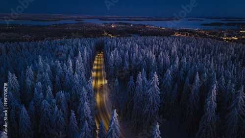 Fotografie Winding road from Puijo tower leading to the center of Kuopio on a moonlit night