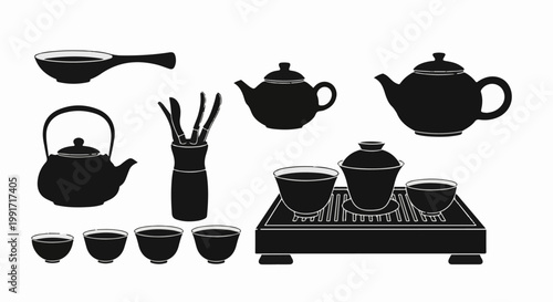 A collection of teapots, cups, and tea ceremony tools arranged on a tray