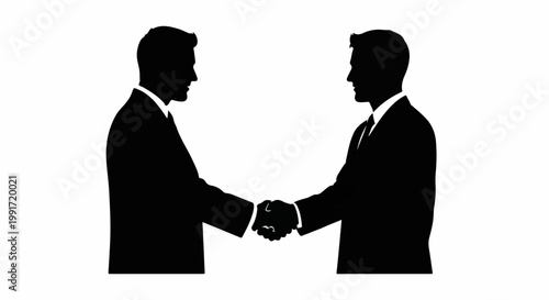 Two businessmen in silhouette shake hands, signifying agreement and partnership