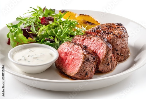 Steak slices, salad, & potatoes in a white dish with creamy sauce