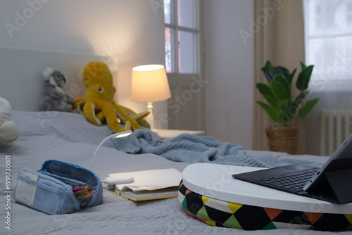 Laptop and Tablet Study Setup on Bed with Desk Lamp and Plush Toys