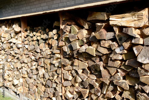 Stack of split firewood logs for winter heating, rustic wood pile