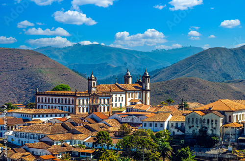 Panoramic view of the historic center of Ouro Preto, Minas Gerais, Brazil. Featuring colonial architecture, baroque churches, and red-tiled roofs against a stunning backdrop  mountains.