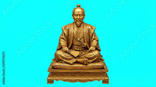 Golden statue of a seated man in traditional japanese clothing with traditional