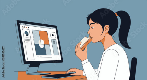 A person with dark hair in a ponytail eats a sandwich while working on a computer