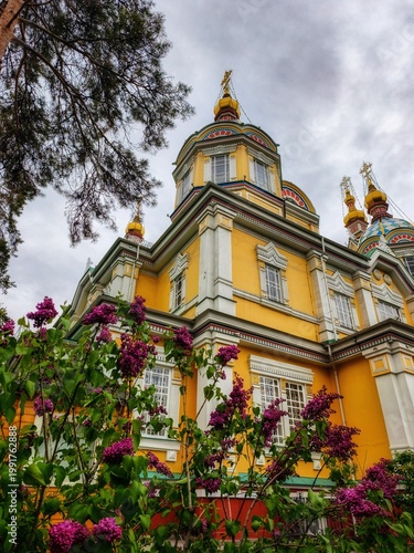 Ascension Cathedral (Zenkov Cathedral) surrounded by blooming lilacs in Almaty, Kazakhstan.