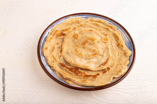 Stack of Plain Fried pancakes on white wooden. side view, close up