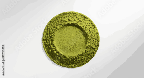 A finely ground green powder sits in a circular pile, creating a concave center