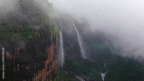 Moving Drone shot of a Huge explosive waterfall shot during heavy monsoon. Three tier waterfall. Tallest waterfall in India. Drone clip 4K60