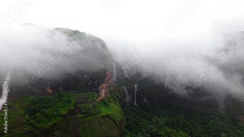 Moving Drone shot of a Huge explosive waterfall shot during heavy monsoon. Three tier waterfall. Tallest waterfall in India. Drone clip 4K60