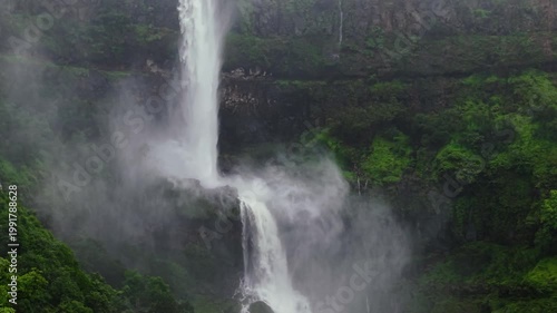 Moving Drone shot of a Huge explosive waterfall shot during heavy monsoon. Three tier waterfall. Tallest waterfall in India. Drone clip 4K60