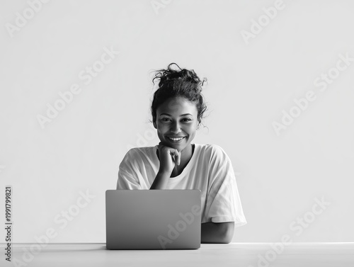 young woman working on laptop in bright modern room