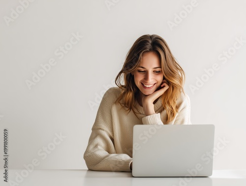 young woman working on laptop in bright modern room