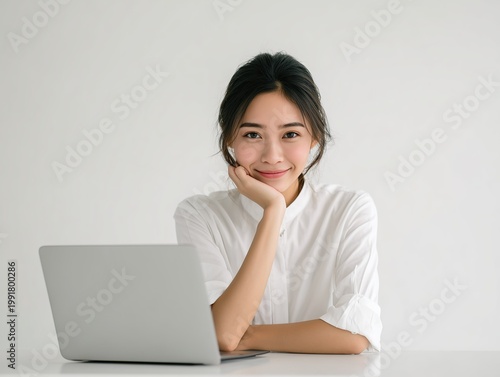 young woman working on laptop in bright modern room