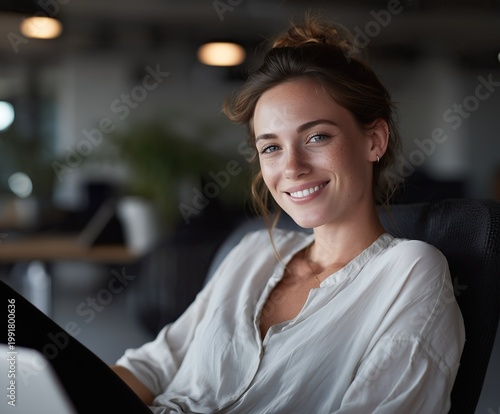 business woman celebrating success on laptop in modern office at night