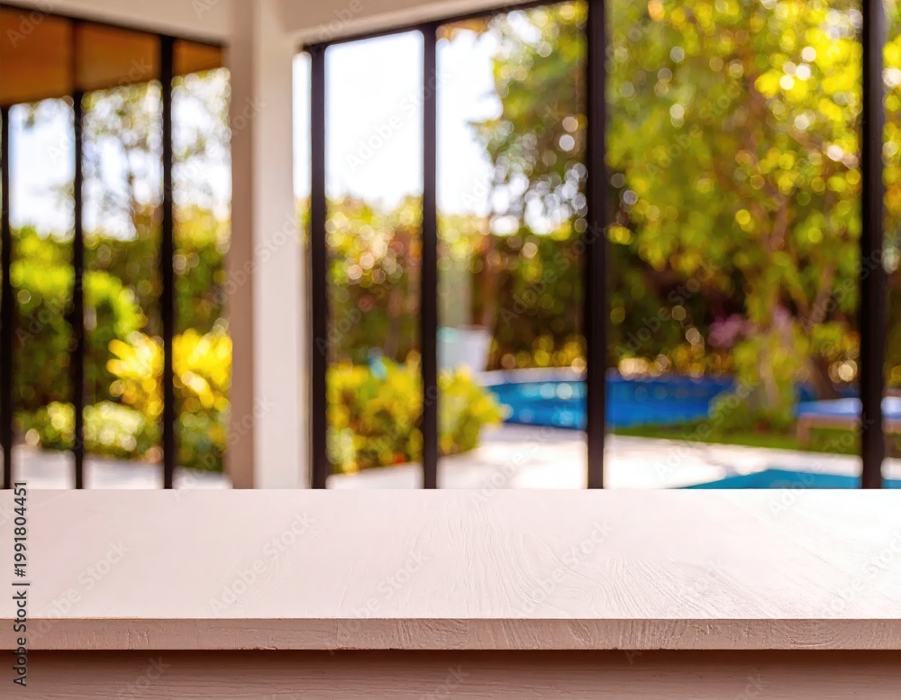 Obraz premium Modern Home Interior Overlooking Lush Green Backyard Pool.