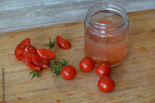 Tomato seed fermentation process with fresh cherry tomatoes and glass jar
