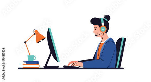 A professional woman with a hair bun wearing a headset works diligently at a computer desk equipped with a vibrant orange lamp and stacked blue books.